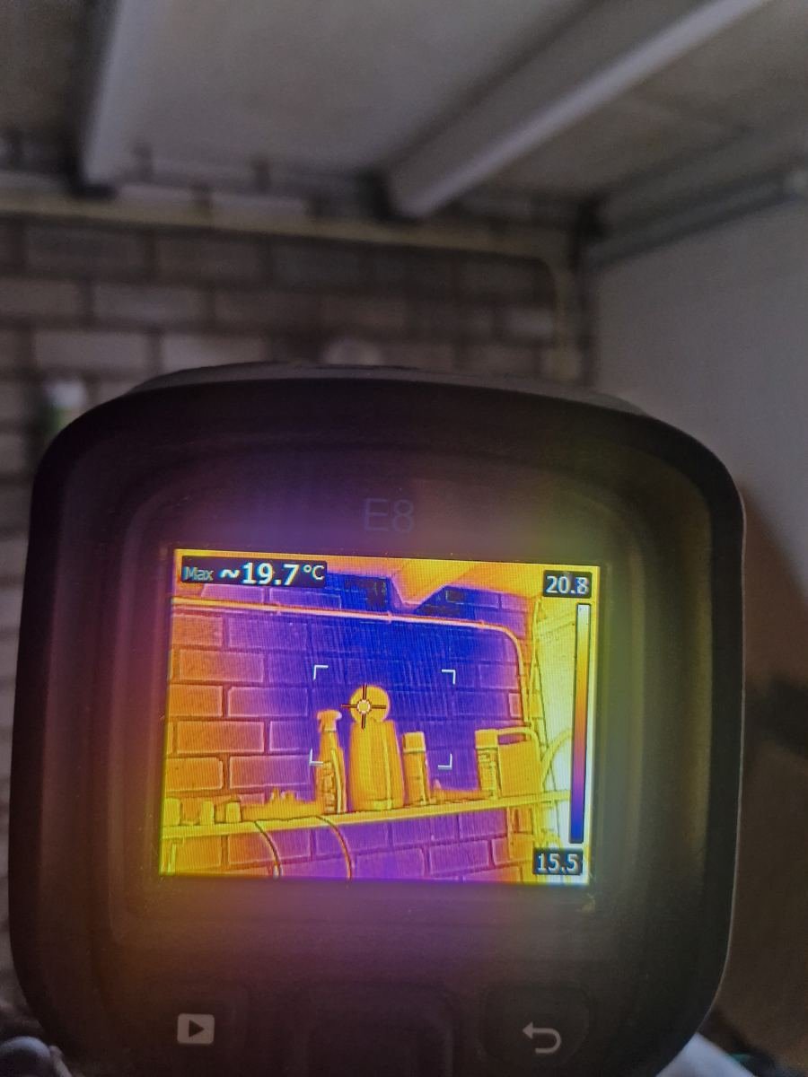 Warmtebeeldcamera toont temperatuurverschillen op een muur in een garage